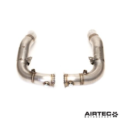 By removing the original restrictive catalytic converters located within the factory OEM downpipes