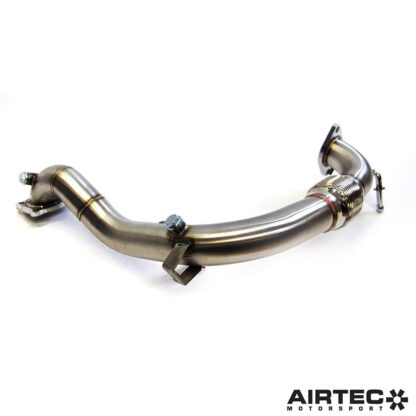 By removing the original restrictive catalytic converter located within the factory OEM downpipe