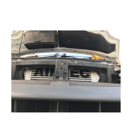 it fits neatly behind the original grille