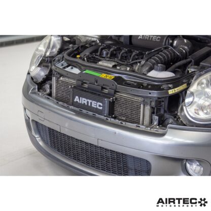 external oil cooler mounted neatly behind the upper grille for direct airflow