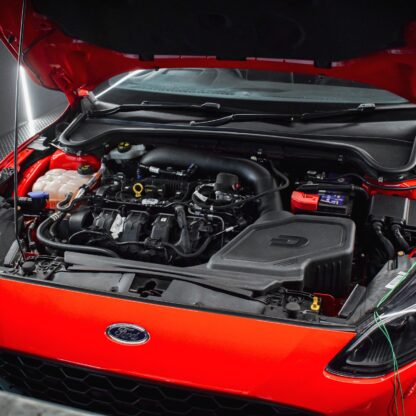 we recommend removing the upper radiator shroud located behind the front bumper and opening up the passenger side slam panel air feed. 
