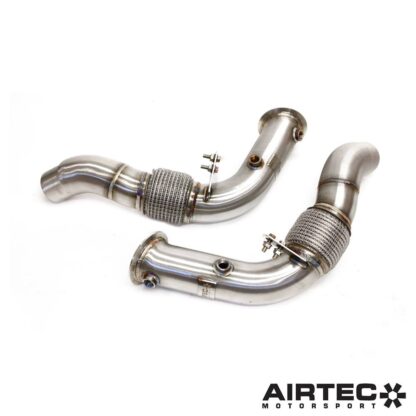 By removing the original restrictive catalytic converters located within the factory OEM downpipes