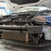 but also the radiator and air conditioning condenser. The front panel in theory is a sandwich pack that houses the auxiliary cooling components. This means in order to increase the size of the intercooler without paying detriment to the performance of the surrounding items